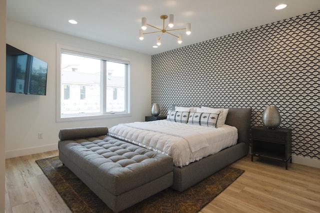 bedroom featuring light hardwood / wood-style floors and an inviting chandelier