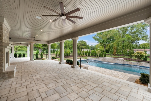 view of pool with ceiling fan, pool water feature, and a patio area