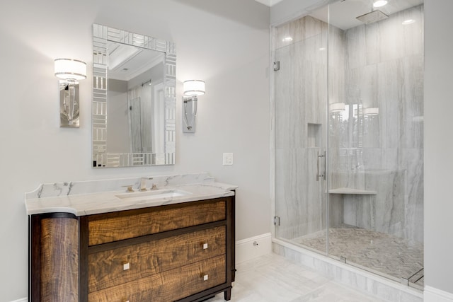 bathroom featuring a shower with door and vanity