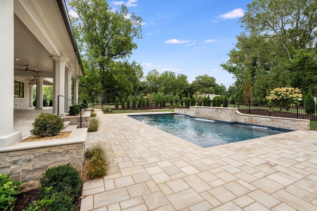 view of swimming pool with pool water feature, a patio area, and ceiling fan