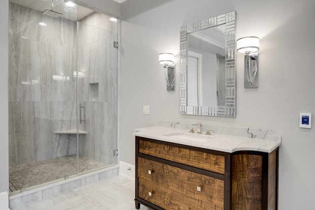 bathroom with a shower with shower door, vanity, and tile patterned floors