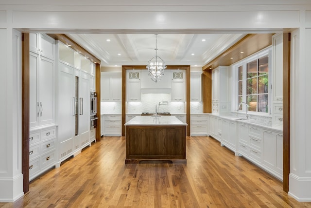 bathroom with wood-type flooring, beam ceiling, tasteful backsplash, and sink