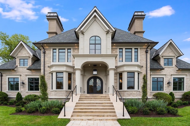 view of front facade featuring a front yard and french doors