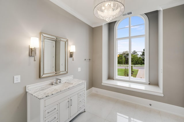 bathroom featuring vanity, a wealth of natural light, an inviting chandelier, and ornamental molding