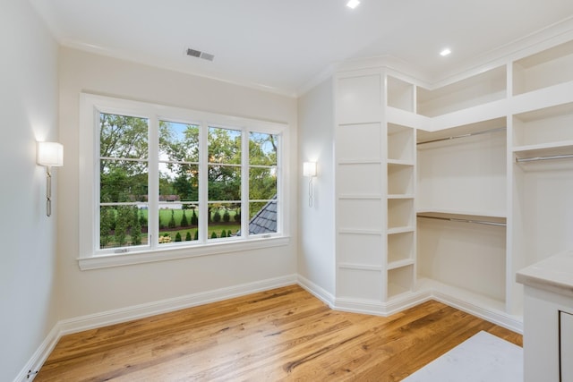 spacious closet with light hardwood / wood-style floors