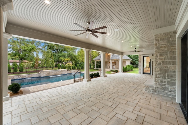 view of patio with ceiling fan, a fenced in pool, and pool water feature