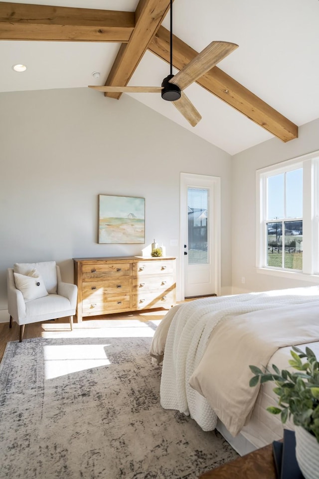 bedroom featuring ceiling fan, lofted ceiling with beams, and hardwood / wood-style flooring