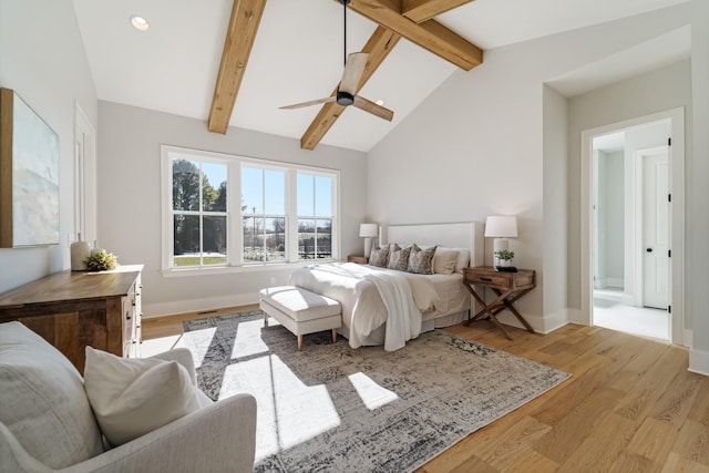 bedroom featuring ceiling fan, vaulted ceiling with beams, and light hardwood / wood-style floors