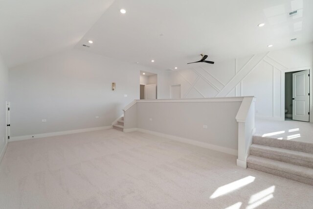 empty room with light carpet, ceiling fan, and lofted ceiling