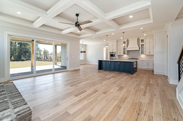 unfurnished living room featuring ceiling fan, light hardwood / wood-style floors, coffered ceiling, and beamed ceiling