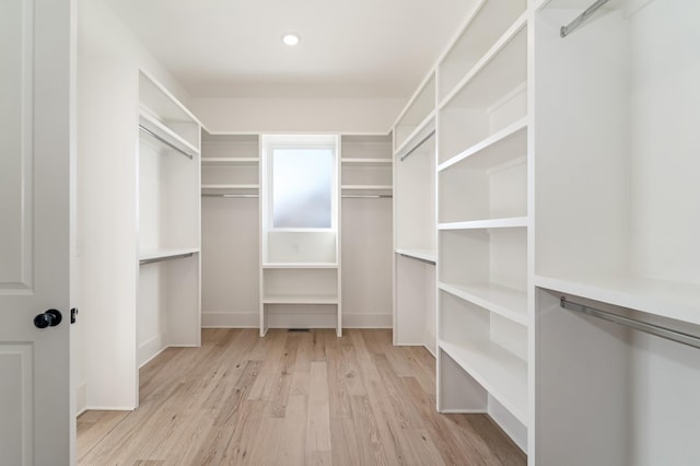 spacious closet with light hardwood / wood-style floors