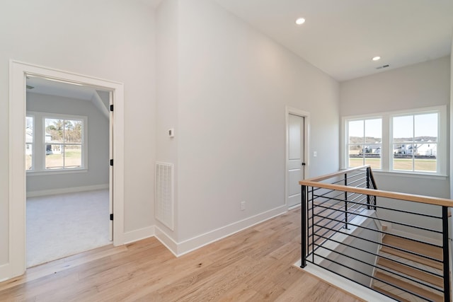 hall featuring light hardwood / wood-style flooring and plenty of natural light