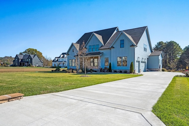 view of front of house with a garage and a front lawn