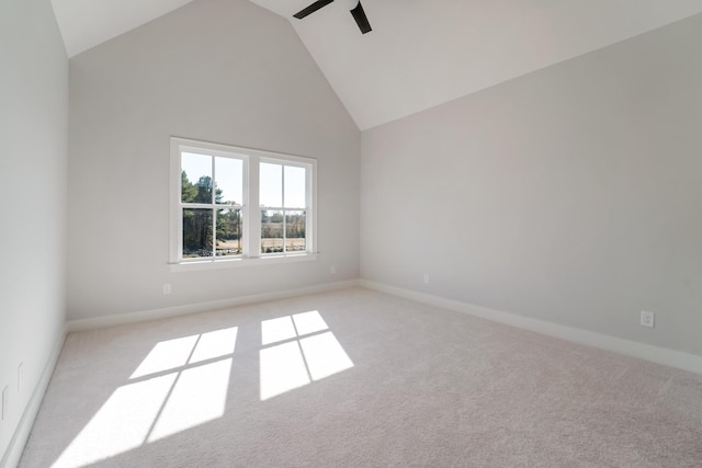 empty room with ceiling fan, light carpet, and high vaulted ceiling