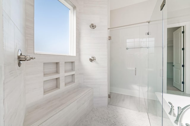 bathroom featuring plenty of natural light and a shower with door