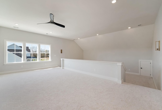 bonus room featuring ceiling fan, light carpet, and vaulted ceiling