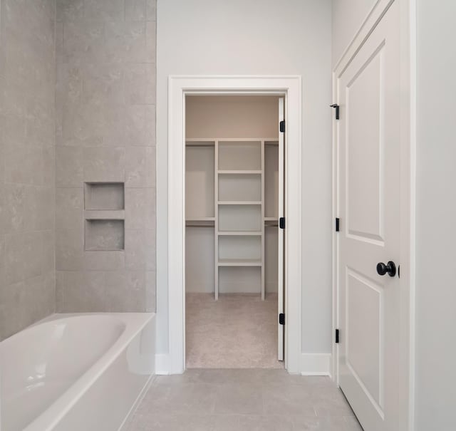 bathroom with bathing tub / shower combination and tile patterned floors