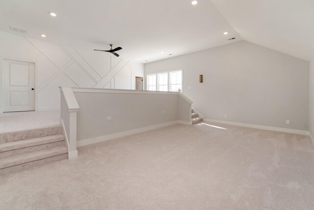 additional living space featuring light carpet, ceiling fan, and lofted ceiling