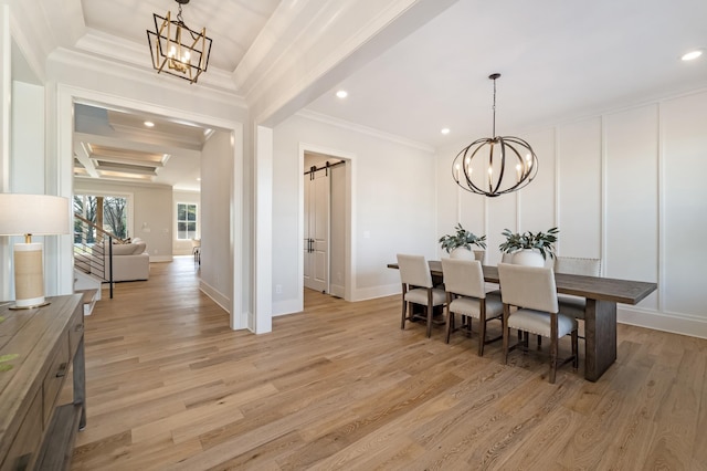 dining room featuring light hardwood / wood-style floors, crown molding, beam ceiling, and a barn door