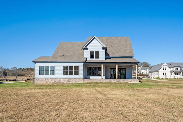 rear view of property with a lawn and a patio area