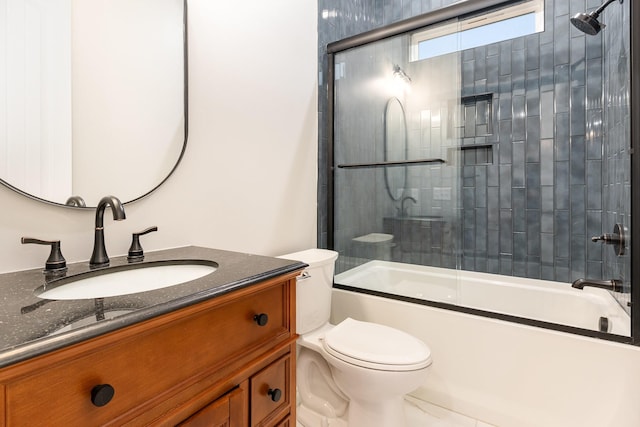 full bathroom with toilet, vanity, and shower / bath combination with glass door