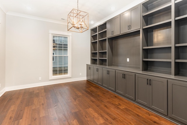 interior space with ornamental molding, a chandelier, and dark hardwood / wood-style flooring