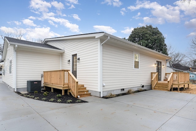 back of house with central air condition unit and a wooden deck