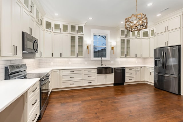 kitchen with white cabinetry, dark hardwood / wood-style flooring, stainless steel appliances, decorative backsplash, and hanging light fixtures