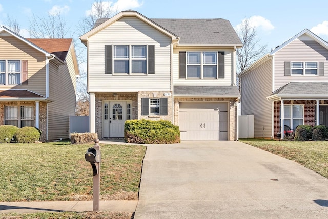 view of front of property featuring a front lawn and a garage