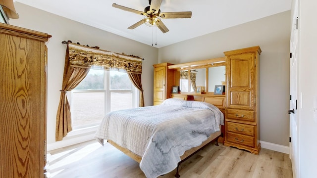 bedroom with light wood-type flooring and ceiling fan