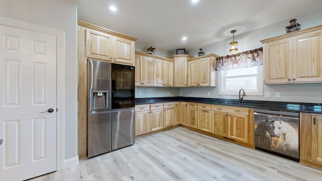 kitchen featuring light hardwood / wood-style floors, stainless steel appliances, light brown cabinets, pendant lighting, and sink