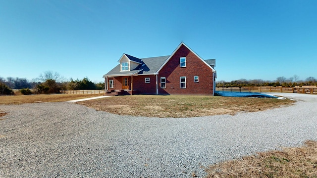 view of home's exterior with a rural view