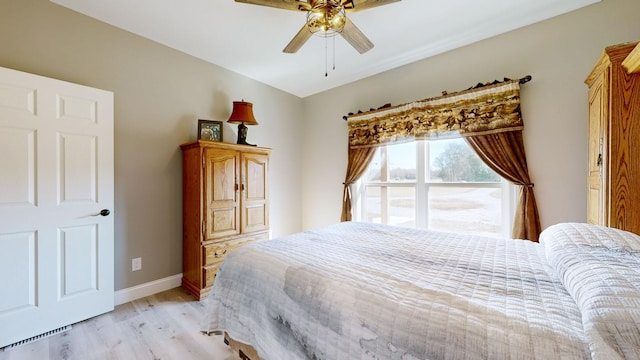 bedroom with ceiling fan and light hardwood / wood-style floors