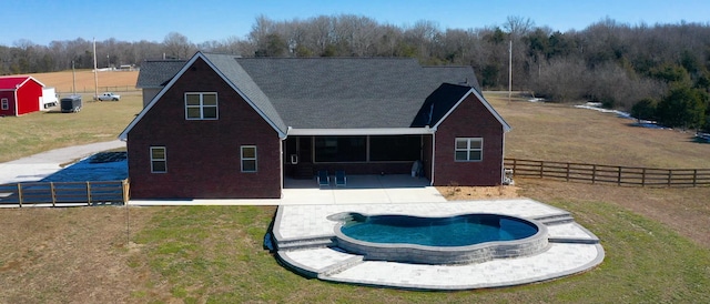 back of property with a yard and a patio