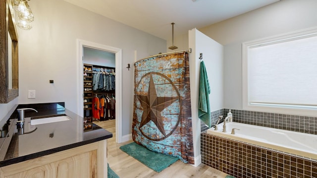 bathroom featuring hardwood / wood-style floors, sink, and shower with separate bathtub