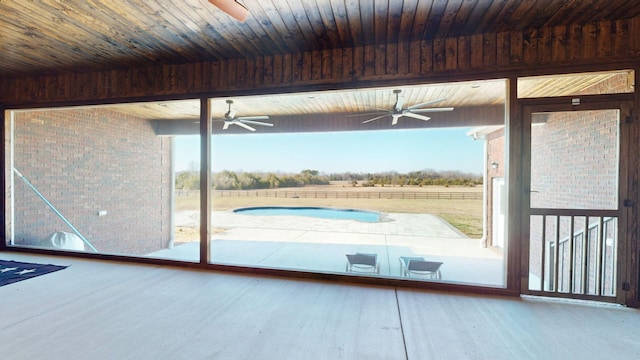 doorway featuring beam ceiling, wooden ceiling, hardwood / wood-style floors, and a rural view