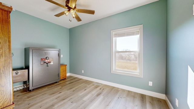 unfurnished bedroom with light wood-type flooring, ceiling fan, and refrigerator