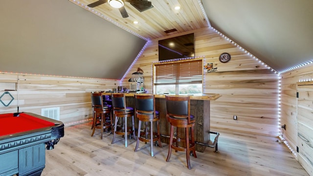 bar featuring hardwood / wood-style flooring, billiards, wood walls, and ceiling fan