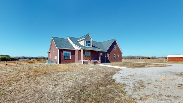 view of front facade with a rural view