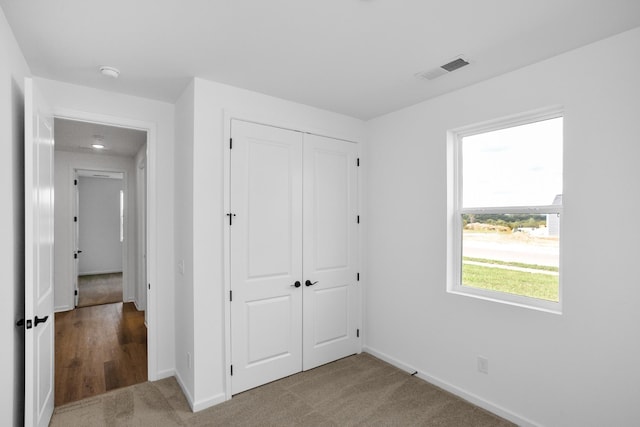 unfurnished bedroom featuring a closet and carpet flooring