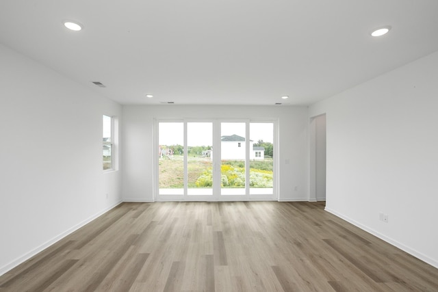 spare room featuring light hardwood / wood-style flooring