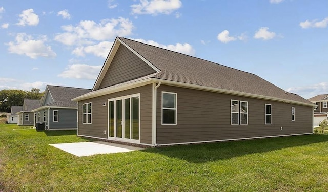 rear view of house featuring a lawn and a patio