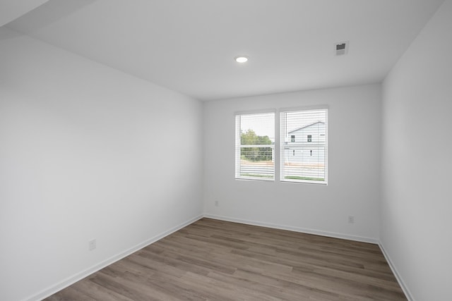 unfurnished room with hardwood / wood-style flooring