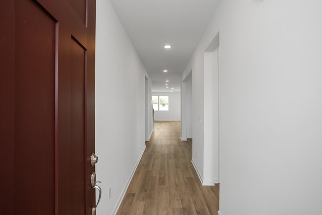 corridor with light wood-type flooring