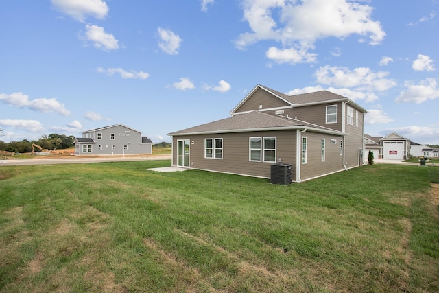 back of property with central AC unit and a lawn