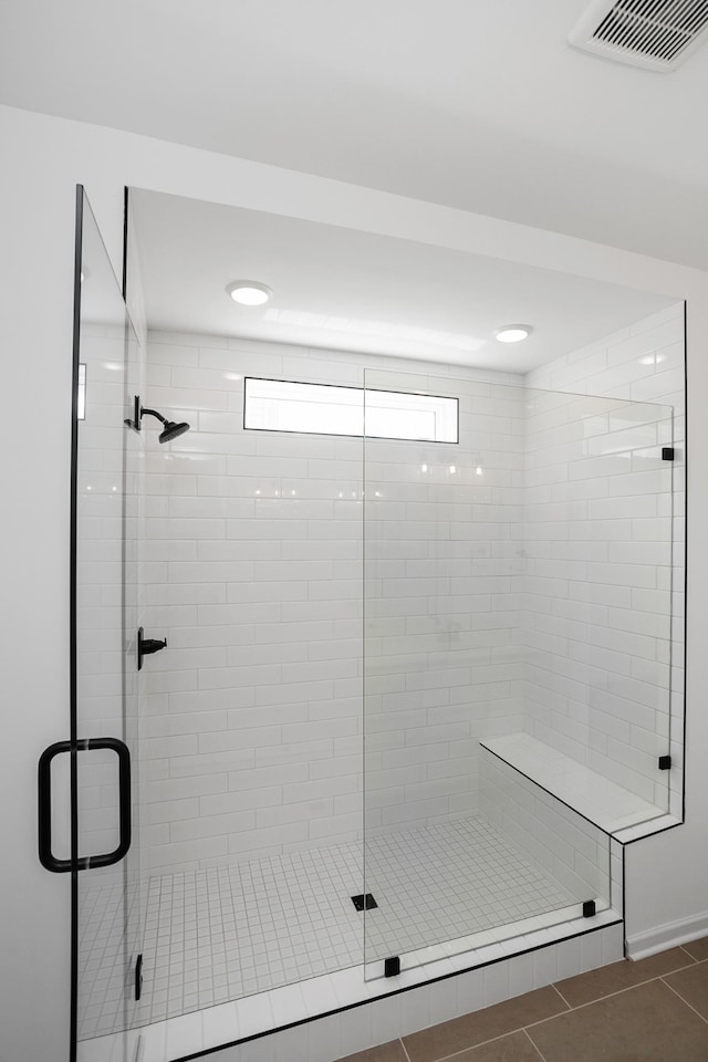 bathroom featuring tile patterned floors and a shower with door