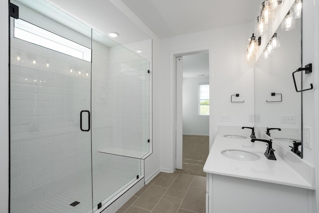 bathroom featuring tile patterned flooring, vanity, and an enclosed shower