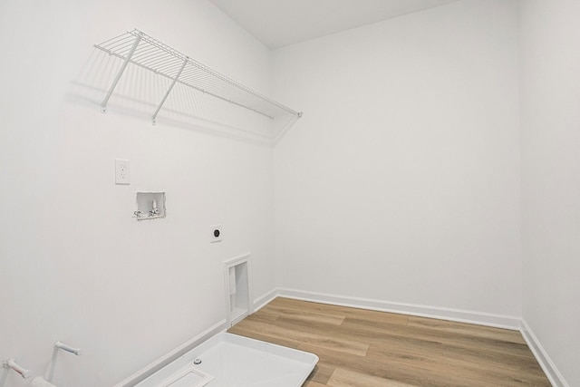 laundry room with hookup for a gas dryer, wood-type flooring, hookup for a washing machine, and electric dryer hookup