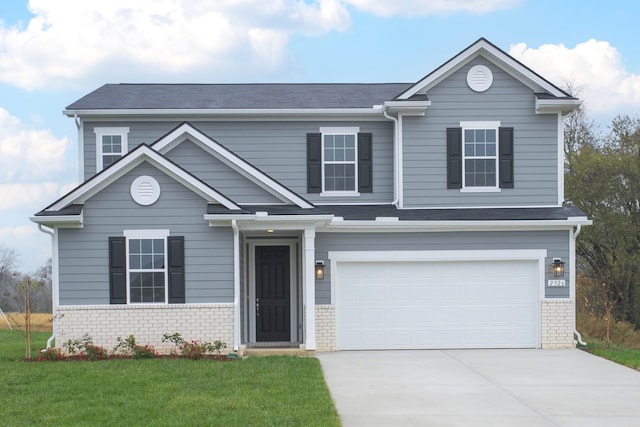 view of front facade with a front yard and a garage