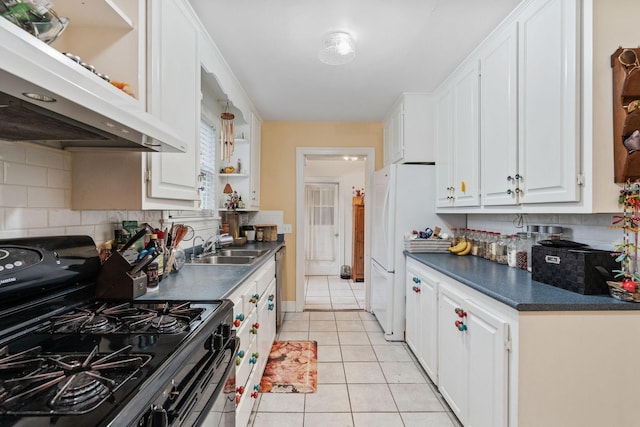 kitchen with white cabinetry, sink, black gas range oven, and light tile patterned floors